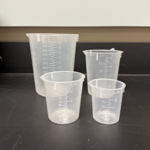 Lab Supplies Beakers Four clear plastic beakers of different sizes (600mL, 250mL. 100mL, and 50mL) arranged on a black lab countertop, each marked with milliliter measurements. Alternative text created using Copilot and edited by a human on February 26, 2026.