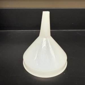 Lab Supplies funnel A wide, translucent plastic funnel with a narrow stem sitting upright on a black lab surface. Alternative text created using Copilot and edited by a human on February 26, 2026.